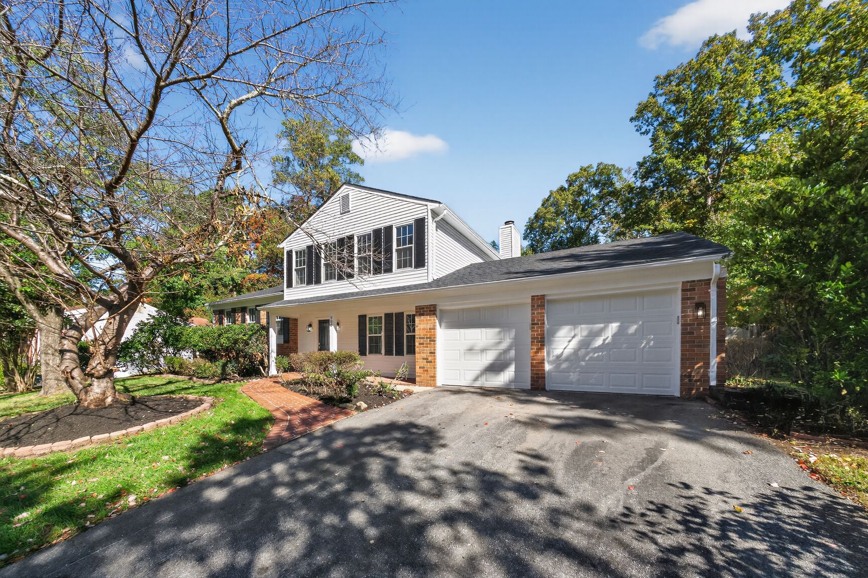 Renovated exterior of 906 Cornish St, Fort Washington MD - new siding, garage doors, and landscaping