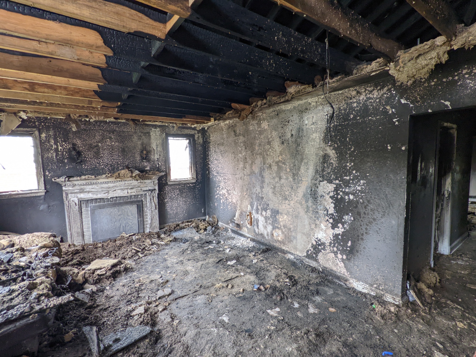 Before renovation – fire-damaged living room, Iron Gate Development flip project DC MD VA